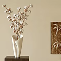 White Vase With Cotton Branches On Dark Wooden Base And Bamboo Leaf Wall Art