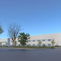 Modern Industrial Factory Building With Surrounding Green Trees And Clear Blue Sky