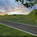 Scenic Road Infrastructure With Guardrails Green Grassland Trees And Sunset Sky