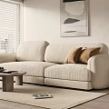 Beige Multi Seater Sofa With Brown Cushions Wooden Coffee Table Area Rug And Abstract Painting
