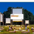 Night Garden Landscape With Large Screens Bonfire And People Gathering On Lawn