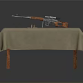 Rifle with orange components on wooden table with beige tablecloth and bullet casings nearby