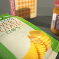 Assorted Packaged Food Items With Corn Flakes Milk Carton Snack Bags And Cans
