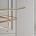 Modern Elegant Spiral Gold Metal Chandelier In Minimalist Interior With Striped Wall
