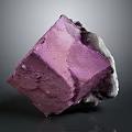Natural Purple Cube Mineral Crystal With Glossy Surface White Gray Edges And Gray Background