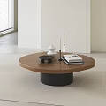 Round Wooden Top Coffee Table With Black Base White Ornament Candles And Books