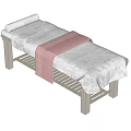 Comfortable Massage Table With Gray Mattress Pink Towel And Metal Frame