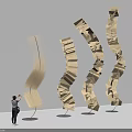 Spiral Wooden Art Installation Made Of Book Pages With Curved Upward Design And Person Nearby