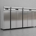 Stainless Steel Commercial Kitchen Refrigerators With Wheels Against White Tiled Wall And Gray Floor