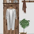Cream Robe With Lace Trim Hanging On Wooden Wall Near Brown Scarf And Green Plant