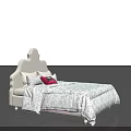 White Double Bed with Unique Headboard Design and Patterned Quilt and Red Accent Pillows