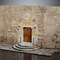 Ancient Stone Building Entrance With Arched Doorway Wooden Door And Stone Steps