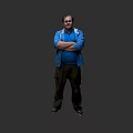 A man wearing a blue jacket with arms crossed standing against gray background