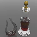 Clear Glass Wine Bottle With Red Liquid Golden Cap And Curved Striped Wine Glass