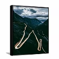 Scenic Mountain Landscape With Winding Roads Light Trails And Dark Cloudy Sky