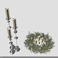 Silver Candle Holders With Candles And Green Wreath Decorations With Small Ornaments