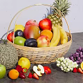 Assorted Fresh Fruits In Wicker Basket With Pineapple Apple Banana Cantaloupe Grapes And Strawberries