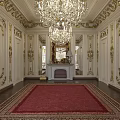 Luxury Clubhouse Interior With Golden Decor White Walls Grand Chandeliers Red Carpet And Fireplace