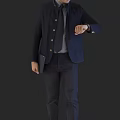 A man in dark blue blazer with tie holding tablet checking watch