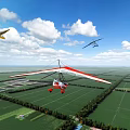 Gyrocopter And Small Airplane Flying Over Green Farmland Under Blue Sky With White Clouds