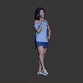 Woman Posing in Blue Off Shoulder Top Blue Shorts and White Shoes Against Gray Background