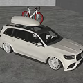 White Mercedes SUV With Red Bicycles Mounted On Roof Rack In Modern Indoor Garage