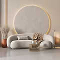 Modern Beige Sectional Sofa with Cushion Throw Blanket Near Round Decorative Wall and Floor Lamp