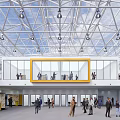 Two Story Building With Steel Frame Roof Yellow Framed Windows And People On Ground Floor