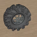 Off Road Tire With Deep Tread Pattern And Shiny Metallic Alloy Wheel Design