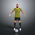 Man in Yellow and Black Striped Jersey Standing with Soccer Ball on Gray Background