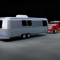 Red Pickup Truck Utility Vehicle Towing Silver Camper Trailer on Road