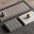 Gray Light Gray White Padded Cushions With Wooden Ball Knit Ornament On Wooden Floor Rug