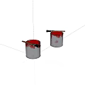 Two White Paint Cans With Red Paint And Brushes On Top