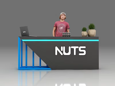 Exhibition Reception Desk Featuring NUTS Logo Blue Frame Gray Countertop Laptop And Potted Plants 3d model
