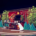 Interactive Area With Traditional Costume Woman And Chinese Style Stage Red Backdrop Bamboo Lanterns