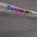 Art Installation with Metal Grid Structure Featuring Colorful Letters Displaying Demons and Monsters Text