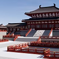 Ancient Chinese Architecture with Traditional Roofs Red Walls and Surrounding Green Grassland Against Distant Mountains