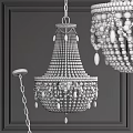 Elegant White Beaded Chandeliers With Intricate Design Hanging On Dark Wall