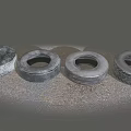 Four Old Worn Tires Placed On Gray Rough Ground Surface 3d model