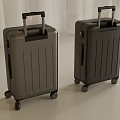 Two Gray Hard Shell Suitcases With Black Handles And Rolling Wheels