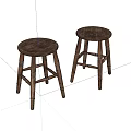 Two Round Wooden Stools With Natural Wood Grain And Carved Legs