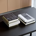 Stacks of Books and Magazines on Dark Table with Various Cover Designs and Light Background Cabinets