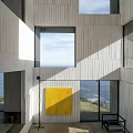 Seaside Detached Villa on Hillside with Concrete Exterior Square Windows and Illuminated Ocean View