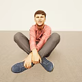 Boy Sitting on Light Floor in Pink Striped Shirt Gray Pants with Hands on Feet