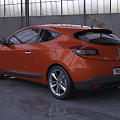 Orange Renault Megane Coupe in Industrial Garage Setting With Sleek Exterior Design
