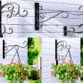 Hanging Vine Plants In Flower Pots On Wrought Iron Hooks White Brick Wall