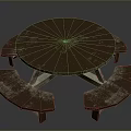Round Wooden Outdoor Picnic Table With Attached Benches And Weathered Surface