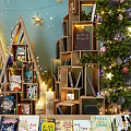 Festive Christmas Shop Window Display With Decorative Trees Stacked Books Stars Moon And Lights