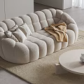 Cozy Two-Seater Sofa With Soft Pillows Blanket On Light Rug And Round Coffee Table