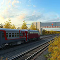 Red Gray Chinese Train Traveling on Railway Tracks with Autumn Trees and Modern Gate